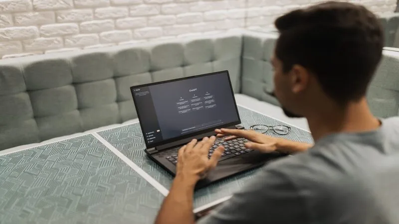 writer using ChatGPT on laptop